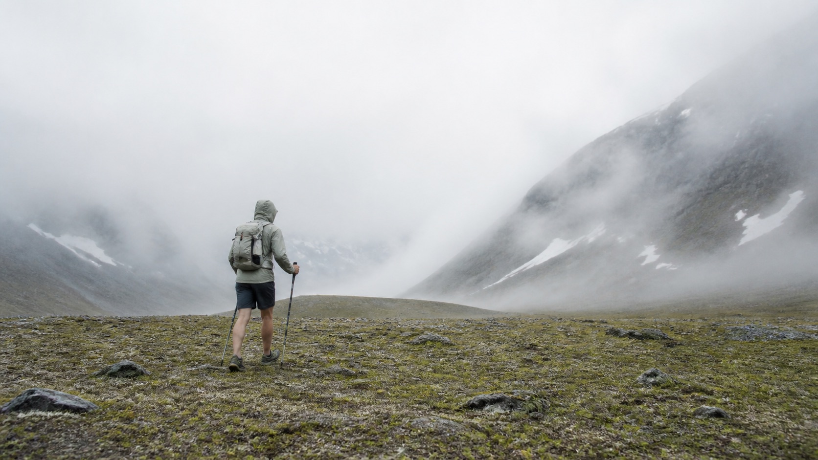 Hiker moving through a high alpine valley